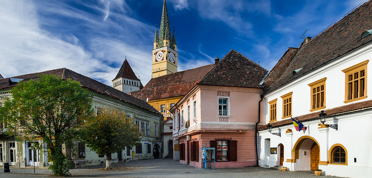 View of blue sky behind Romania Medias where you'll find teaching opportunities in Romania