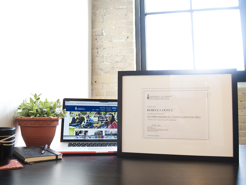 TEFL certificate on a desktop and homepage of laptop with the TEFL Online Course
