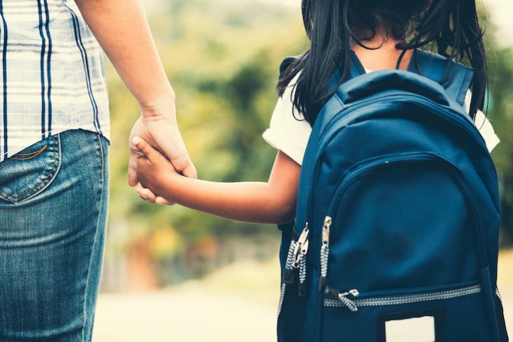 teacher holding childs hand