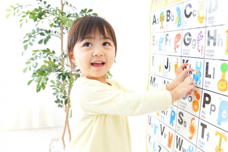 Little girl learning English in an ESL classroom.