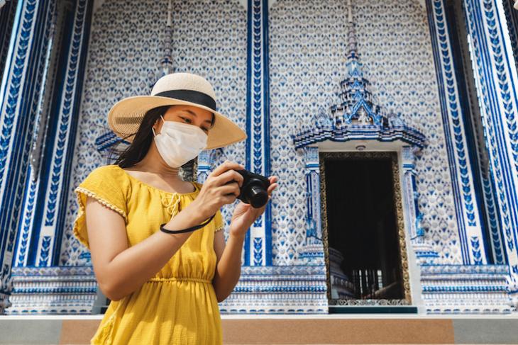 Photo of woman traveling in Thailand during covid.