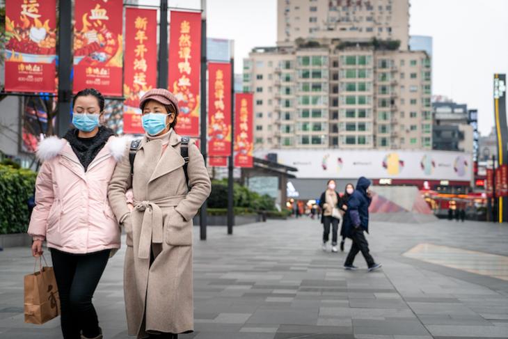 Photo of women walking the streets of China. 