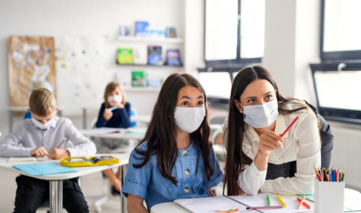 teacher helps student with homework