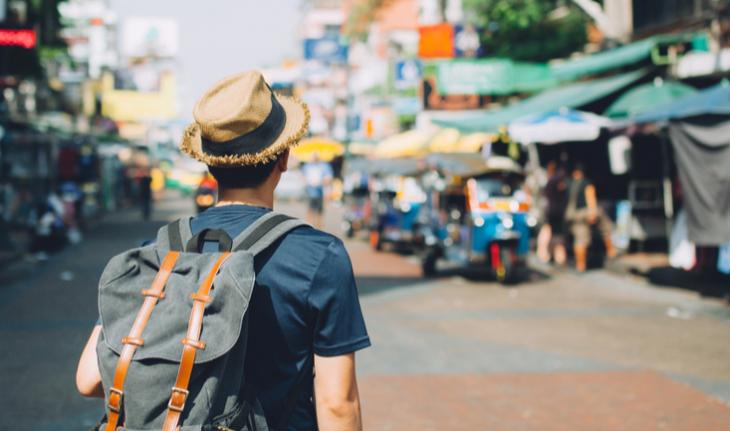 traveling man walking down khao san road outdoor market in bangkok, thailand for how to make your teaching resume stand out article