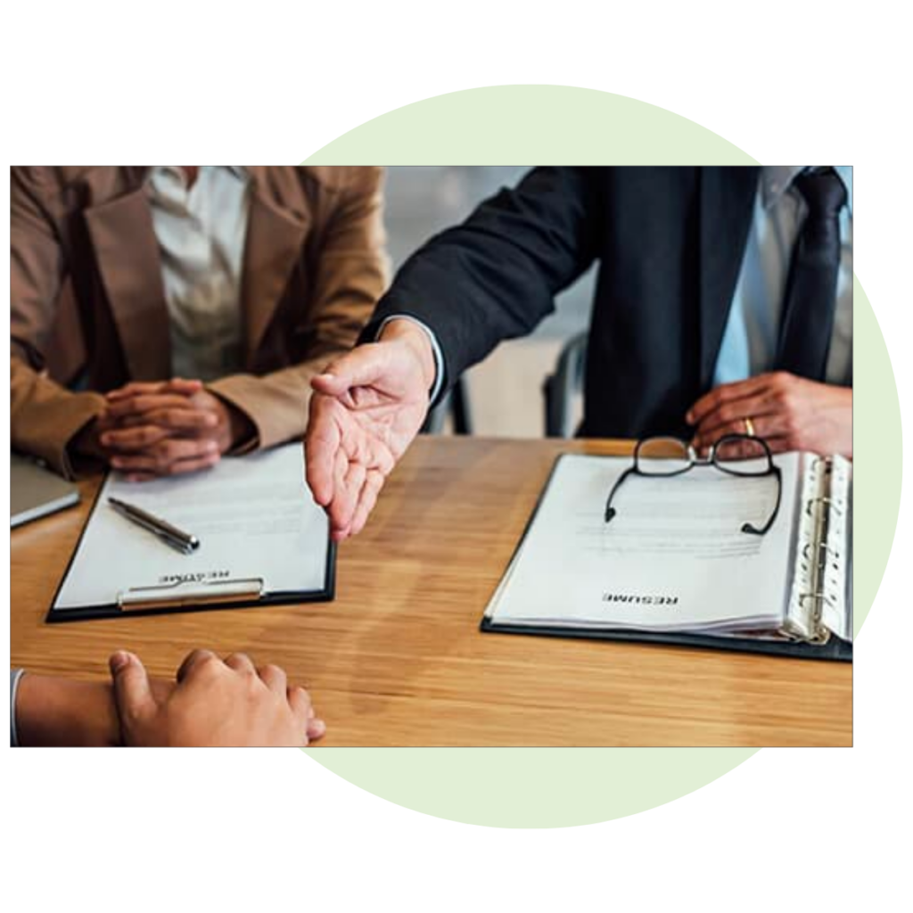 hand shake reaching across an office desk